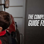 Mechanic in red jacket closely inspecting diesel truck engine components in a repair shop. Text reads: The Complete Diesel Truck Maintenance Guide for Canadian Operators