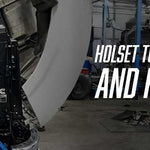 Mechanic working on a red Cummins engine inside a heavy-duty truck at a diesel repair shop, turbo components laid out on a workbench in the foreground. Text reads: HOLSET TURBO: COMMON PROBLEMS AND REPAIR OPTIONS