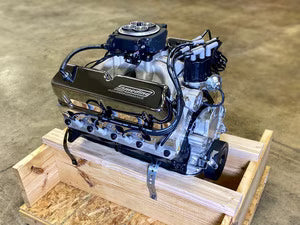 Engine on a wooden pallet with a concrete floor background