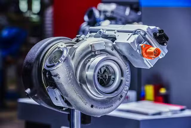 Turbocharger on a stand with a blurred workshop background