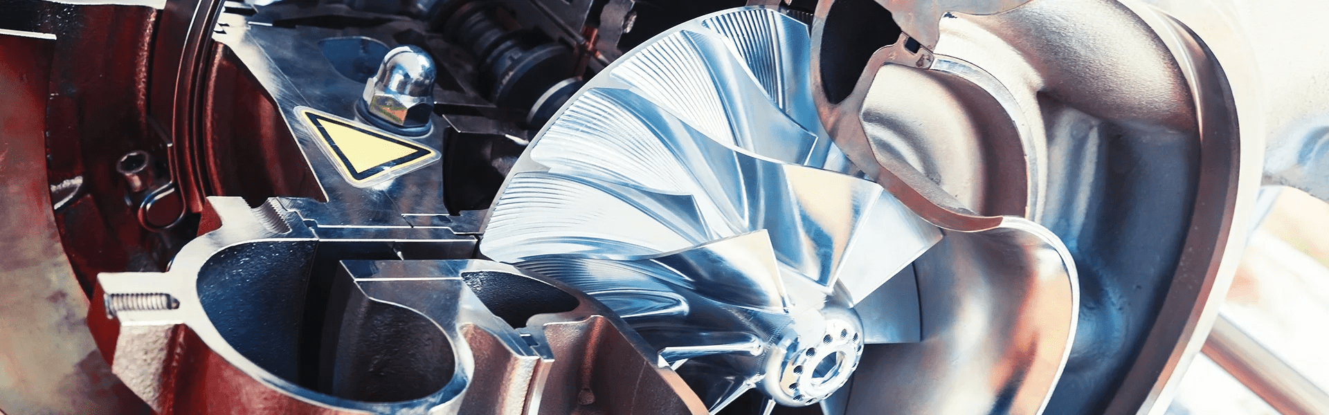 Close-up of a car engine with a transparent section showing internal components.