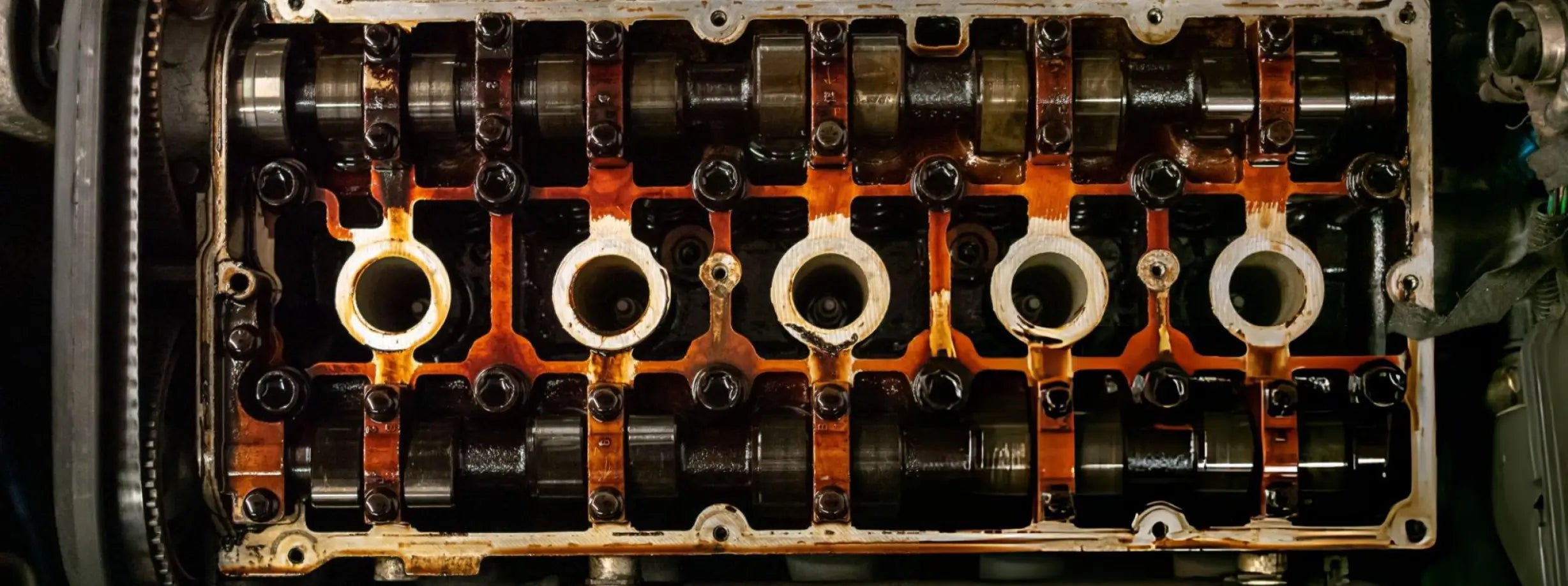 Close-up of an engine valve train with camshaft and rocker arms.